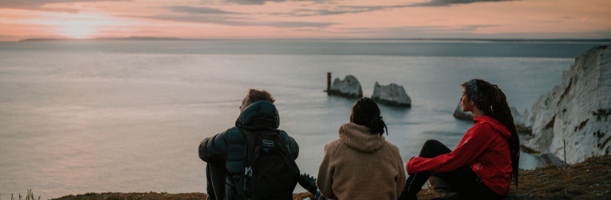 Group of people looking out to the Needles from the clifftop on the Isle of Wight